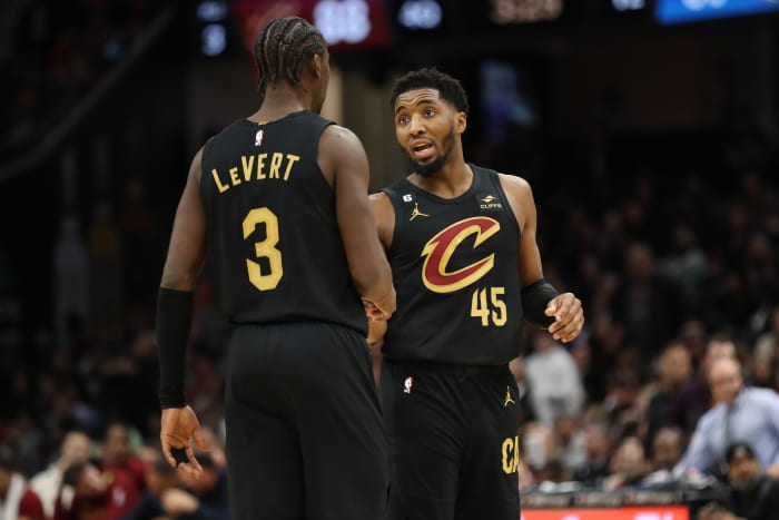 Dec 17, 2022; Cleveland, Ohio, USA; Cleveland Cavaliers guard Donovan Mitchell (45) talks with guard Caris LeVert (3) in the second half against the Dallas Mavericks at Rocket Mortgage FieldHouse. Mandatory Credit: Aaron Josefczyk-USA TODAY Sports